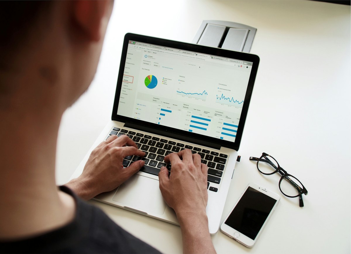 A person working with an analytics dashboard on a laptop at a desk